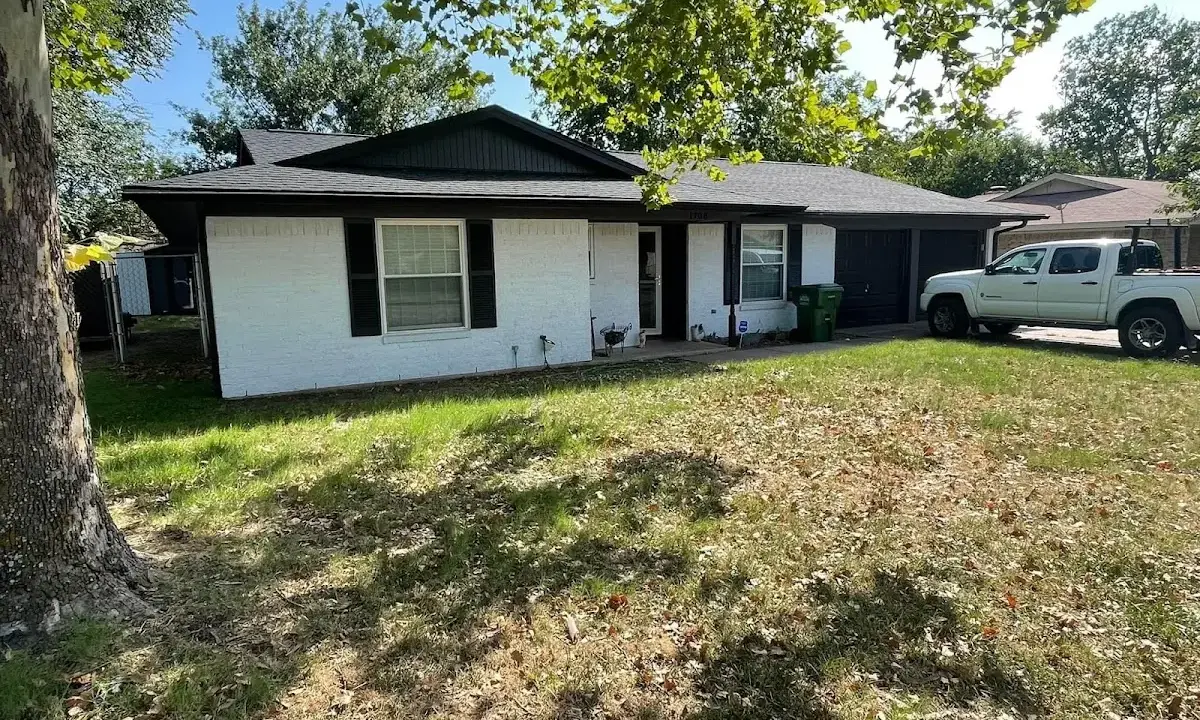 Professional roofing crew working on a residential roof in Liberty